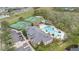 Aerial view of community clubhouse featuring a swimming pool, tennis courts, and parking at 14216 Mailer Blvd, Orlando, FL 32828