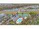 Aerial view of community clubhouse with pool, tennis courts, and surrounding homes at 14216 Mailer Blvd, Orlando, FL 32828