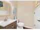 Bathroom features a wood vanity with solid surface countertop, and neutral walls at 14216 Mailer Blvd, Orlando, FL 32828