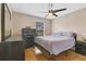 Cozy bedroom offers hardwood floors, dark furniture set, and a ceiling fan at 14216 Mailer Blvd, Orlando, FL 32828