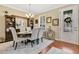 Elegant dining room with hardwood floors, stylish chandelier, and a decorative mirror adding depth to the space at 14216 Mailer Blvd, Orlando, FL 32828