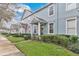 Inviting townhouse exterior showcasing manicured front lawn, brick walkway, and classic architectural details at 14216 Mailer Blvd, Orlando, FL 32828