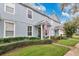 Townhouse exterior with a well-maintained lawn and attractive landscaping, creating a welcoming curb appeal at 14216 Mailer Blvd, Orlando, FL 32828