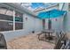 Enclosed patio area featuring brick pavers, a dining set with umbrella, and access to the home at 14216 Mailer Blvd, Orlando, FL 32828