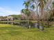 Scenic backyard view with mature trees and peaceful pond at 1431 Milledge Ln, Davenport, FL 33896