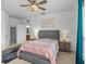 Comfortable bedroom features a ceiling fan and an ensuite bathroom at 1431 Milledge Ln, Davenport, FL 33896