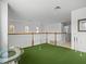 Upper level bonus room with putting green and wood railing at 1431 Milledge Ln, Davenport, FL 33896