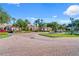 Exterior of the community clubhouse entrance, showcasing landscaped grounds and brick-paved driveway at 1431 Milledge Ln, Davenport, FL 33896