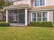 Exterior view of the home showing the screened patio and well-maintained landscaping at 1431 Milledge Ln, Davenport, FL 33896