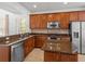 Well-equipped kitchen boasts stainless steel appliances and granite countertops at 1431 Milledge Ln, Davenport, FL 33896