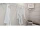 Walk-in closet with wire shelves, white robes on hangers, and a gray storage bin at 1442 Ironbark Bnd, Davenport, FL 33837