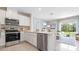 Modern kitchen with stainless steel appliances, white cabinetry, and a view of the backyard at 1442 Ironbark Bnd, Davenport, FL 33837