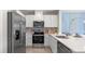 Modern kitchen featuring stainless steel appliances, white cabinets, and bright countertops at 1442 Ironbark Bnd, Davenport, FL 33837