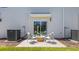 Back patio seating area with sliding glass door and view of trees at 1442 Ironbark Bnd, Davenport, FL 33837