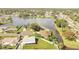 Aerial view of a home with a backyard overlooking a large lake with surrounding residential neighborhood at 161 Laurel Way, Kissimmee, FL 34743