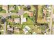 Aerial view of a home with a spacious backyard, nearby street, pond, and adjacent properties at 161 Laurel Way, Kissimmee, FL 34743