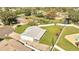 An aerial view of the property, showcasing its large lot, nearby pond, and mature trees at 161 Laurel Way, Kissimmee, FL 34743