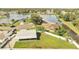 Aerial view of a home with a backyard overlooking a large lake with surrounding residential neighborhood at 161 Laurel Way, Kissimmee, FL 34743