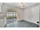 Bright dining area with gray tile flooring and sliding door to the screened patio at 161 Laurel Way, Kissimmee, FL 34743