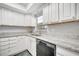 Kitchen sink with granite countertops, sleek faucet, and white cabinets at 161 Laurel Way, Kissimmee, FL 34743