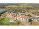 Aerial view of a lakeside condo complex with a pool, parking, and lush landscaping, perfect for relaxed living at 16300 County Road 455 # 607, Montverde, FL 34756