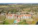 Aerial shot showcasing condo buildings with a pool, parking, and natural landscapes at 16300 County Road 455 # 607, Montverde, FL 34756