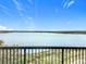 Scenic lake view showcasing tranquil waters and distant shoreline from a balcony with metal railing at 16300 County Road 455 # 607, Montverde, FL 34756