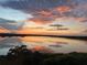 Spectacular lake view at sunset featuring orange and pink hues reflecting on the water at 16300 County Road 455 # 607, Montverde, FL 34756