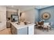 Kitchen and dining area with grey cabinets, stainless steel appliances, and an island at 173 River Front Way, Edgewater, FL 32141