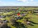 A beautiful aerial view of a home located in a golf course community with serene ponds at 19 Meadowlake Ct, Winter Haven, FL 33884