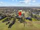 A beautiful aerial view of a home located in a golf course community with ponds and mature trees at 19 Meadowlake Ct, Winter Haven, FL 33884