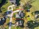 Aerial view of the property, showing the home's layout, pool, driveway, and surrounding landscape within property lines at 19 Meadowlake Ct, Winter Haven, FL 33884