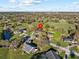 Aerial view of a residential neighborhood with mature trees and well-manicured lawns at 19 Meadowlake Ct, Winter Haven, FL 33884