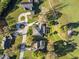 Aerial view of the property, showing the home's layout, pool, driveway, and surrounding landscape at 19 Meadowlake Ct, Winter Haven, FL 33884