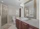 Elegant bathroom features a glass enclosed shower, large mirror, and a neutral color palette at 19 Meadowlake Ct, Winter Haven, FL 33884