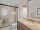 Bathroom featuring tiled shower, glass door and vanity with granite countertop at 19 Meadowlake Ct, Winter Haven, FL 33884