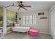 Bedroom featuring shuttered windows, ceiling fan and pink ottoman at 19 Meadowlake Ct, Winter Haven, FL 33884