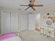 Bedroom with closet doors, ceiling fan and vanity table at 19 Meadowlake Ct, Winter Haven, FL 33884