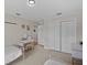 Bright bedroom featuring two beds, neutral carpet, and white closet doors at 19 Meadowlake Ct, Winter Haven, FL 33884