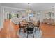 Open dining area with a round table, seating for five, and an elegant chandelier at 19 Meadowlake Ct, Winter Haven, FL 33884