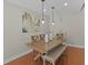 Dining area showcasing a wooden table, bench seating, and modern pendant lighting at 19 Meadowlake Ct, Winter Haven, FL 33884