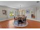 Cozy dining room featuring a round wooden table and a shuttered window for natural light at 19 Meadowlake Ct, Winter Haven, FL 33884