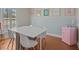 Dining room featuring laminate flooring, retro mini fridge and modern table at 19 Meadowlake Ct, Winter Haven, FL 33884