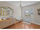 Bright foyer featuring wood floors, a decorative mirror and a stylish accent bench at 19 Meadowlake Ct, Winter Haven, FL 33884