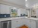 Bright kitchen with white cabinetry, modern appliances, and blue tiled backsplash at 19 Meadowlake Ct, Winter Haven, FL 33884