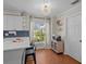 Charming bright kitchen with white cabinetry, modern appliances, and a modern chandelier at 19 Meadowlake Ct, Winter Haven, FL 33884