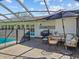 Enjoy the outdoors on the patio, featuring a grill, dining table, and comfortable seating perfect for relaxing near the pool at 19 Meadowlake Ct, Winter Haven, FL 33884