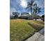 Backyard view showcasing the home's layout and well-manicured lawn at 21636 King Henry Ave, Leesburg, FL 34748