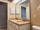 Bright bathroom featuring a double vanity and large mirror at 21636 King Henry Ave, Leesburg, FL 34748