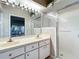 Bathroom with double sink vanity and glass enclosed shower at 21636 King Henry Ave, Leesburg, FL 34748